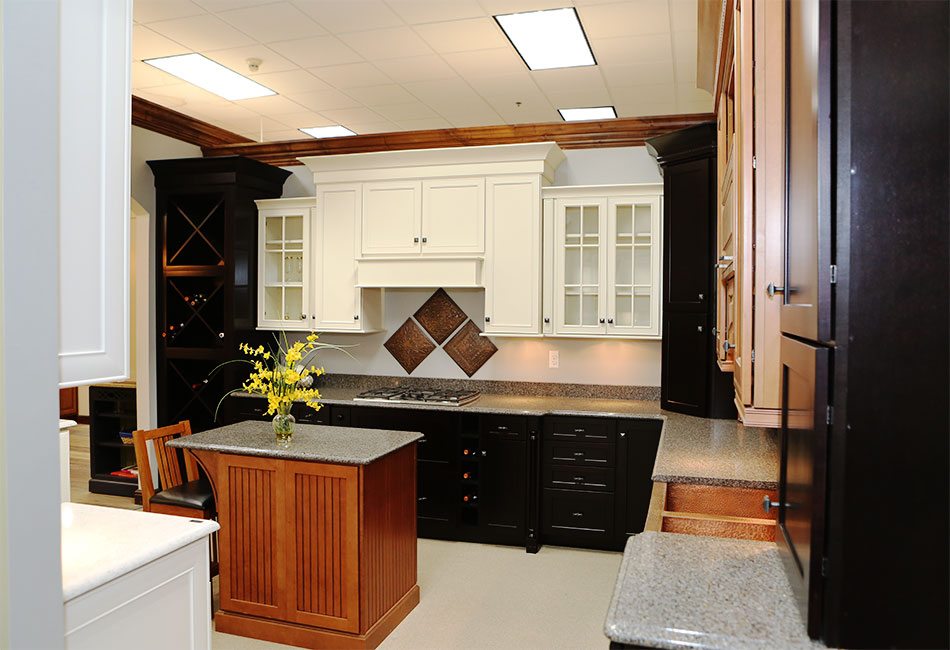 A display room in the Moehl Millwork Showroom displaying black and white cabinets as well as countertop work.
